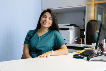 Female receptionist working the computer