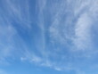 Dark blue sky, on a hot summer morning with white clouds, cirrus are tiny streaks scattered around. The calm sky with little light indicates a good day to relax.Sky nature background
