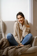 © arthurhidden - Smiling lady in smart trendy wear is sitting on armchair. Smiling, sitting in relaxing atmosphere indoors at home, nice design. Comfort and cozy girlish time