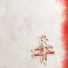 Wall Mural - Christmas tree on flour background. White flour looks like snow. Top view