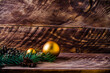 cones and branches on wooden boards with a large Christmas ball.
