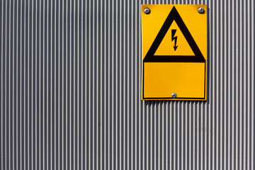 yellow plate on an electric fence