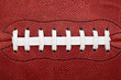 © Winslow Productions/Tetra Images - Close up of laces on american football ball