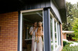 © Jessica Peterson/Tetra Images - Mother with baby son (18-23 months) standing behind window