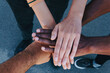 © David Munoz/ADDICTIVE STOCK - From above cropped unrecognizable African American people putting hands together standing on the street