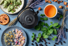 Herbal Tea, Natural, Organic, And Healthy, A Tea Pot, Cup, And A Variety Of Ingredients, Shot From Above On A Blue Background