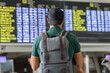 © Pablo Garcia/ADDICTIVE STOCK - Back view of unrecognizable male traveler with backpack checking schedule on departure board while standing in international airport and waiting for flight