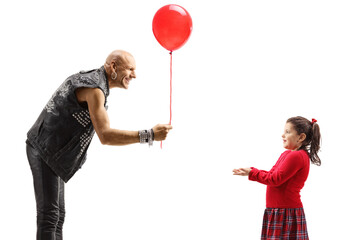 Punk giving a red balloon to a little girl