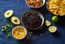 Ingredients For Cooking Chilaquiles - Black Beans, Tortilla Chips, Corn And Salsa