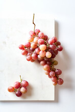 A Cluster Of Pink Muscatel Grapes On White Background