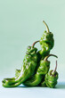 © Bego Simon/ADDICTIVE STOCK - Closeup of dry green jalapeno peppers arranged on light green background and showing concept of elderly wrinkled people