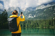© Carles Alonso/ADDICTIVE STOCK - Back view of unrecognizable woman photographing high mountains on cellphone during trip in Dolomites