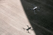 © Gabriel Trujillo/ADDICTIVE STOCK - From above modern drone flying in empty concrete walkway casting shadows on sunny day