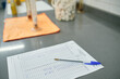 © Fatima Guisado/ADDICTIVE STOCK - High angle of scientific report of experiment placed on table with pen in contemporary chemical laboratory