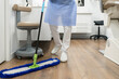 © Javier Ballester/ADDICTIVE STOCK - Crop anonymous medical staff in uniform washing floor with mop in modern dental cabinet