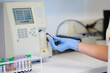 © Gabriel Trujillo/ADDICTIVE STOCK - Assorted blood sample tubes on table near crop anonymous medical technologist with professional hematology equipment during diagnostic process in laboratory