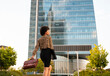 © Jose Carlos Cerdeno/ADDICTIVE STOCK - Back view of well dressed African American female worker carrying bag while strolling in business district