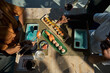 © Philippe Degroote/ADDICTIVE STOCK - Top view of crop anonymous African American female friends sitting at table with sushi and rolls while eating in Asian restaurant