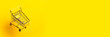 flying empty trolley on a bright yellow background. Close-up. Banner.