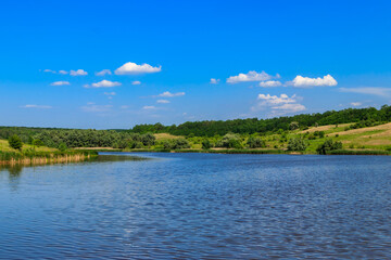 Canvas Print - Summer landscape with beautiful lake, green meadows, hills, trees and blue sky