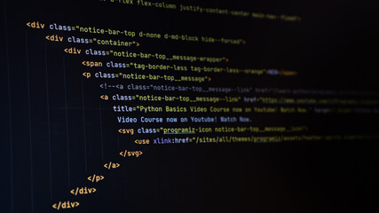 Selected html code in code IDE editor on monitor screen. Software developer programming code background