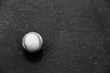 Sticker - Baseball rain delay concept with ball on wet concrete background.