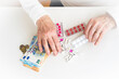 © Zhanna - An older retired woman is counting money and saving it for medicines, medical treatment and insurance. Taking care of your health and wise investment.