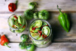 Selective focus. Jars of fermented green tomatoes. Pickling green tomatoes. Probiotics and fetmented foods.
