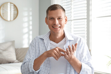 Poster - Man talking to his coworkers through video conference indoors, view from webcam