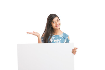 Wall Mural - Cheerful attractive young women holding white board on white background.