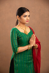 Canvas Print - Pretty Indian young woman praying studio shot