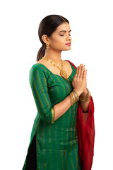 Wall Mural - Pretty Indian young woman praying isolated on white.