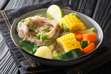 Poster - Caldo de Res is a Mexican beef soup that's hearty enough to be a main meal and the perfect dish to make during the winter closeup in the plate on the table. horizontal