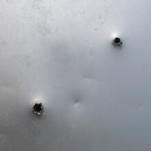 Bullet Ragged Hole In Sheet Metal Wall Or Door