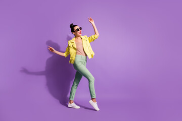 Full body profile side photo of young attractive positive smile woman enjoy go walk look empty space isolated over purple color background