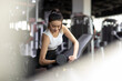 © Blue Jean Images - Young woman working out with dumbbell at gym