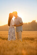 © Blue Jean Images - Happy young couple having fun in wheat field