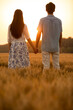 © Blue Jean Images - Happy young couple having fun in wheat field