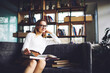 © BullRun - Woman with books sitting in couch