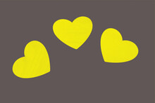 3 Yellow Hearts On A Gray Background. Valentine's Day. Illuminating And Ultimate Gray Background. Pattern In Trendy New Colors 2020