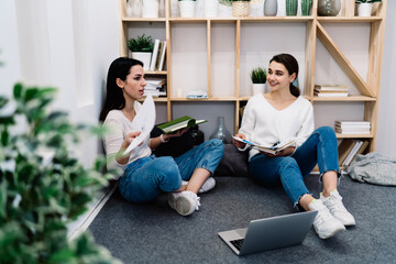 Canvas Print - Positive woman working with colleague on floor