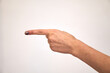 © Vladimir - Caucasian female hand shows gestures and raises her finger to the side. The finger indicates the direction to the left. Exclamation and attention.