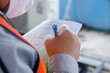 © kitawit - engineer white record on data sheet for maintenance work, worker wear mask for protect COVID-19 when working