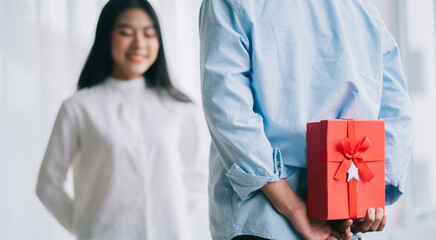 Asian girl feels happy and surprised to receive gifts from her boyfriend on valentine's day