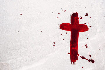 Fototapeta christian cross painted with red blood on stone background. copy space. good friday. passion, crucifixion of jesus christ. christian easter holiday. crucifix, gospel, salvation concept