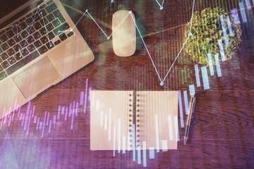 Stock market graph and top view computer on the table background. Double exposure. Concept of financial education.