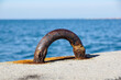 Old steel mooring bollard pole on a pier, rusty mooring .