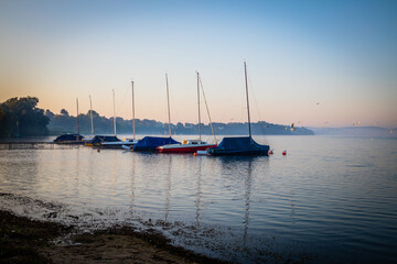 Wall Mural - Sunrise with sailing boats at the Great Ploen lake in Schleswig-Holstein, Germany