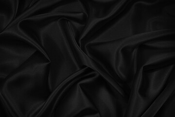 Wall Mural - Abstract black background. Black silk satin fabric texture background. Beautiful soft folds on the fabric. Black elegant background for your design.