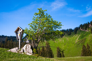 Wall Mural - Cross standing on the way, crucifix in the bavarian alps near lake Tegernsee, Bavaria, Germany